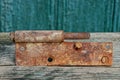 Old rusty brown door hinge lies on a gray table Royalty Free Stock Photo