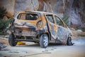 Old rusty burnt car at road side Royalty Free Stock Photo