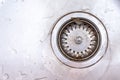 Old rusty calcified drain hole in the kitchen sink with limescale and scurf scum, copy space