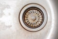 Old rusty calcified drain hole in the kitchen sink with limescale and scurf scum, copy space