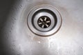 Old rusty calcified drain hole in the kitchen sink with limescale and scurf scum, kitchen and house cleaning