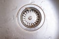 Old rusty calcified drain hole in the kitchen sink with limescale and scurf scum