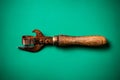 Old rusty can opener on a green background Royalty Free Stock Photo
