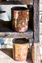 Old rusty cans, forgotten on old wooden stairs