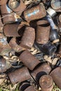 Old rusty cans lie on the ground and dry grass in nature Royalty Free Stock Photo