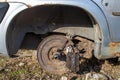 An old rusty car with a falling off wheel. Royalty Free Stock Photo