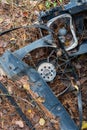 Old rusty car parts lamp sockets and clutch on autumn forest floor surrounded by leaves dry sticks in Bulgaria, Eastern Europe Royalty Free Stock Photo
