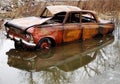 An old rusty car in a puddle arrived Royalty Free Stock Photo