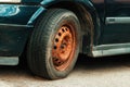 Old rusty car wheel rim and worn tire Royalty Free Stock Photo