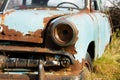 Old, rusty car wreck front and lamp detail Royalty Free Stock Photo