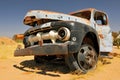 Old and rusty car wreck at the last gas station before the Namib desert. Solitaire, Namibia Royalty Free Stock Photo