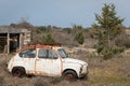 A old rusty car wreck standing in a garden Royalty Free Stock Photo