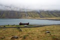 Old and rusty cargo ship wreckage laying on the fjord bank in Mjoifjordur in east Iceland Royalty Free Stock Photo