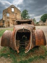 Old rusty cars left behind in Oradour-sur-Gllane, France