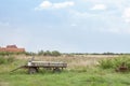 Old and rusty cart, empty, standing  next to a field during a cloudy afternoon in Uljma, a small Serbian village of Vojvodina Royalty Free Stock Photo