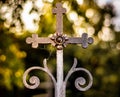 Old rusty Catholic cross on the gate leading to the cemetery. Spider in the corner. Royalty Free Stock Photo