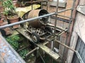 An Old Rusty Cement Mixer Suspended in the Air, Very Unsafely on Some Scaffolding