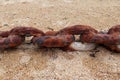 Old rusty chain on the beach sand Royalty Free Stock Photo