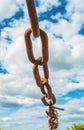 Old rusty chain on the field on the background of the sky Royalty Free Stock Photo