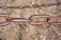 Old rusty chain on the field on the ground background Royalty Free Stock Photo