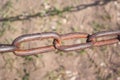 Old rusty chain on the field on the ground background Royalty Free Stock Photo