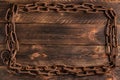 Old rusty chain frame on wooden background Royalty Free Stock Photo