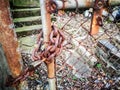 Old rusty chain and master key locked on the rusty fence gate. Royalty Free Stock Photo