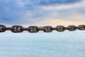 The old rusty chain on sea background. Royalty Free Stock Photo