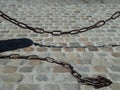 Old Rusty Chains on cobblestones Royalty Free Stock Photo
