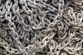 Old rusty chains used in fishing industry full of aged red rust