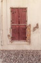 Old rusty closed dark red wooden door on yellow cement textured Royalty Free Stock Photo