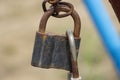 Old rusty closed lock on a chain