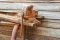 Old rusty clumping device on weathered work bench