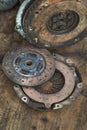 Old rusty clutch and the clutch disc lies on the counter in the garage. Royalty Free Stock Photo