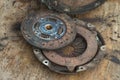 Old rusty clutch and the clutch disc lies on the counter in the garage. Royalty Free Stock Photo