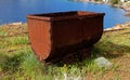 Old rusty coal tub on tracks, on the sea cliff in Megalo Livadi village, Serifos island, Greece Royalty Free Stock Photo