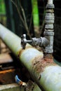 Old rusty connection of two water pipes with faucet, concept of wear of pipes Royalty Free Stock Photo