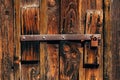 Old rusty corroded padlock on wooden farm barn door Royalty Free Stock Photo