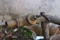 old rusty crooked water pipe with faucet