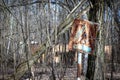 Old rusty crosswalk sign among trees in radioactive zone in Pripyat city. Chernobyl Exclusion Zone, Ukraine Royalty Free Stock Photo