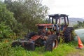 Old rusty defective tractor in farmyard