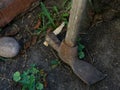 An old rusty digger pick stands on the ground. Close Royalty Free Stock Photo