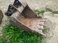 old and rusty dirty digger excavator bucket on the street. Royalty Free Stock Photo