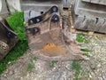 old and rusty dirty digger excavator bucket on the street. Royalty Free Stock Photo