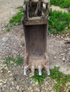 old and rusty dirty digger excavator bucket on the street. Royalty Free Stock Photo