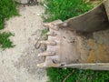 old and rusty dirty digger excavator bucket on the street. Royalty Free Stock Photo