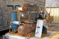 Old rusty discarded air compressor powered by electric motor Royalty Free Stock Photo