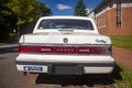 an old rusty Dodge dynasty car