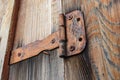 Old and rusty door hinge holding a wooden gate closed Royalty Free Stock Photo