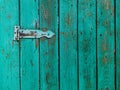 Old rusty door hinge on a wooden fence door. Royalty Free Stock Photo